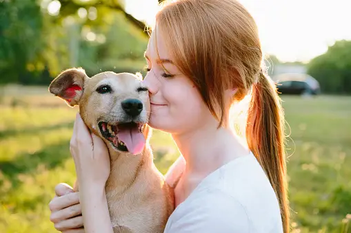 A woman loving a dog